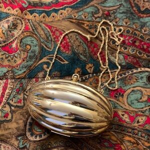 Andre Cellini Shiny Gold Oval Clutch with Chain.